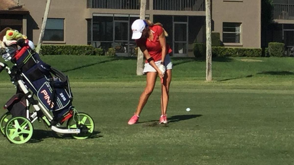 Manatee's Gabrielle Tomeo fires her approach to the 18th hole during Monday's Class 3A-Region 5 golf tournament at Capri Isles Golf Club.