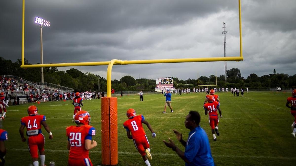 The Southeast High School Seminoles make a brief appearance on the field before their game against Palmetto High School was cancelled due to lightning on Friday night at Southeast High School in Bradenton. The game is rescheduled for Saturday afternoon at 1 p.m.