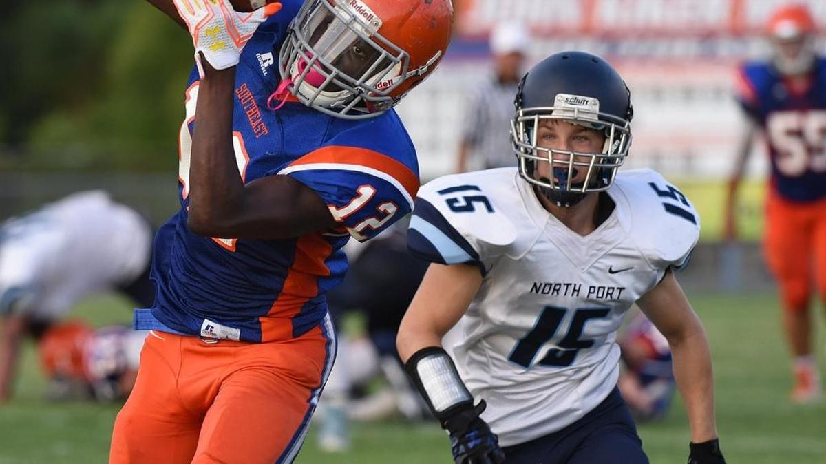 Southeast’s Bradley Tresalus catches a pass and runs for a touchdown as Andrew Bosma defends during Thursday’s spring game against visiting North Port.