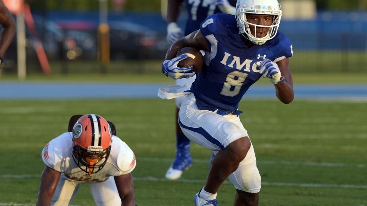 IMG Academy’s Jhamon Ausbon runs against Miami Gardens Carol City in a preseason classic at IMG Academy Stadium in Bradenton.