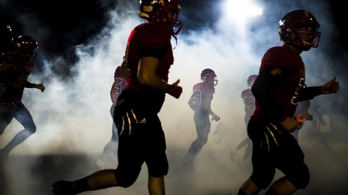 Palmetto players enter the field in a cloud of smoke Friday as they take on visiting Punta Gorda Charlotte. The Tigers join Manatee and Braden River in this year’s high school football playoffs.