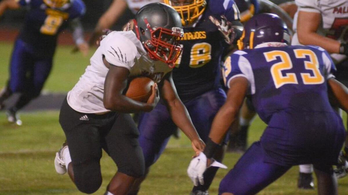 Running back Elijah Davis gains yardage during Palmetto’s victory against Booker in Sarasota Friday.
