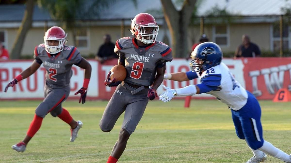 Manatee's Sir Williams evades Armwood High's Salah Odeh in Friday night's pre-season game against Armwood High at Hawkins Stadium.