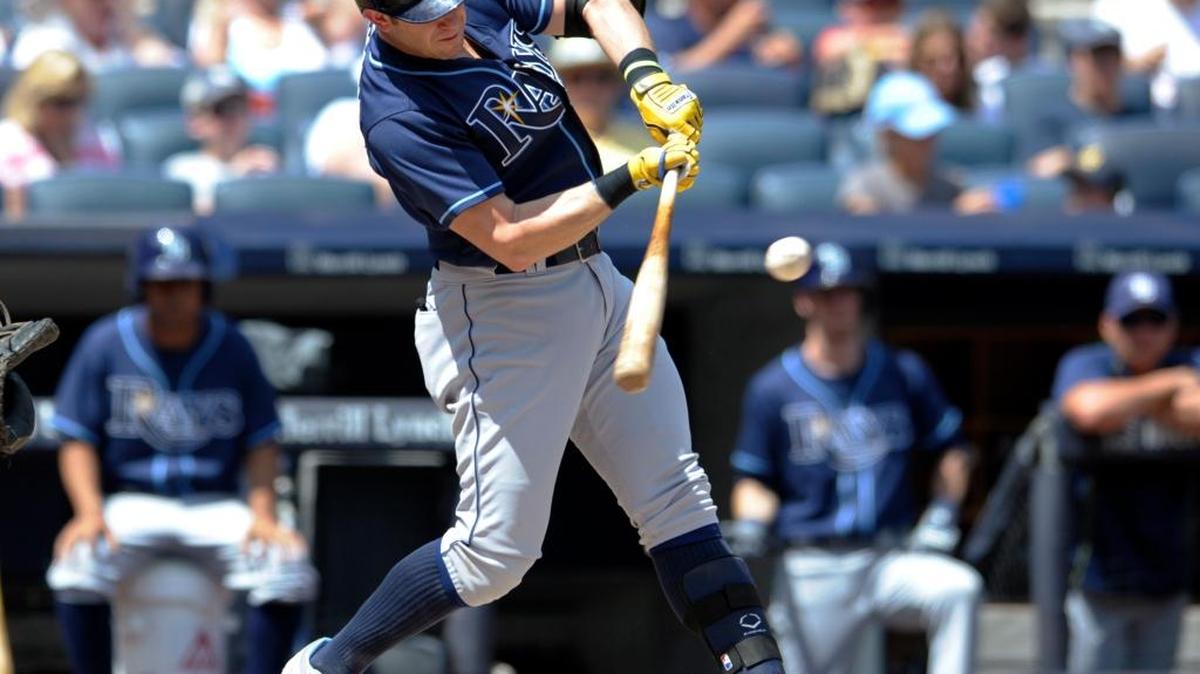 Tampa Bay’s Evan Longoria hits an RBI double during the first inning Sunday against the New York Yankees. Longoria finished with three hits.