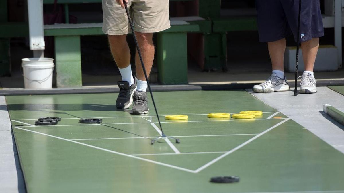 Shuffleboarders compete in a tournament at Trailer Estates.