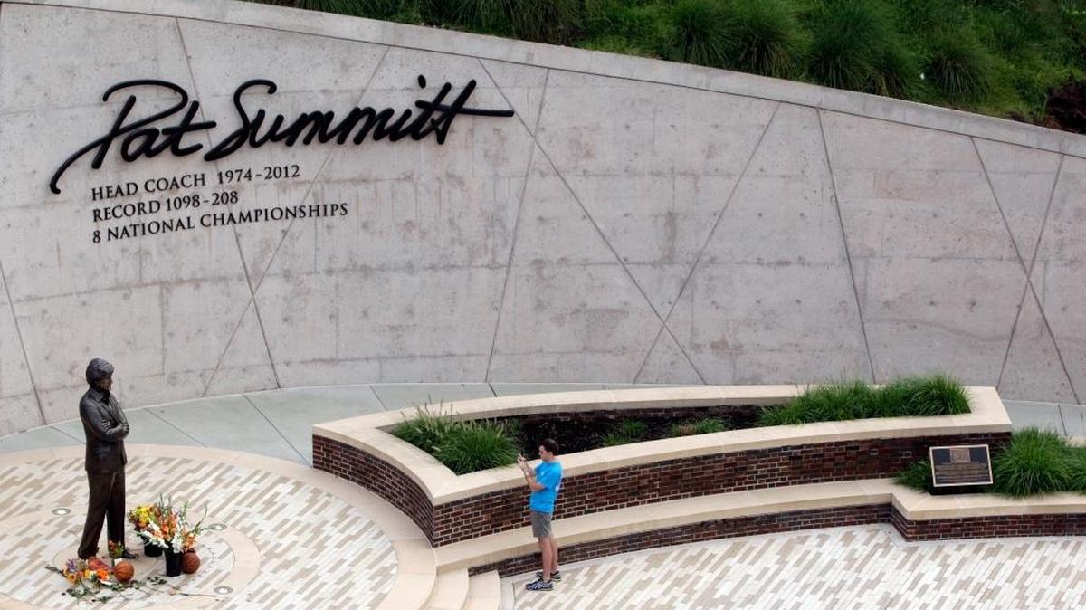 A fan takes a photograph at the Pat Summitt statue on the University of Tennessee campus Tuesday, June 28, 2016, in Knoxville, Tenn. Summitt, the winningest coach in Division I college basketball history who uplifted the women's game from obscurity to national prominence during her career at Tennessee, died Tuesday. She was 64.