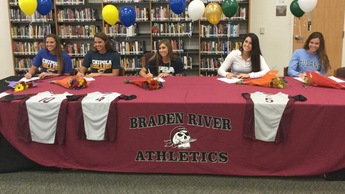 Ali Yawn, center (shown during a signing day ceremony in November), pitched a one-hitter in the Class 7A-District 9 final against Lennard High School on Thursday in Seffner at Armwood High School. Joining Yawn in this photo are Casey and Brooke Farrow (at left) and Sarah Crawford and Emma King (at right).
