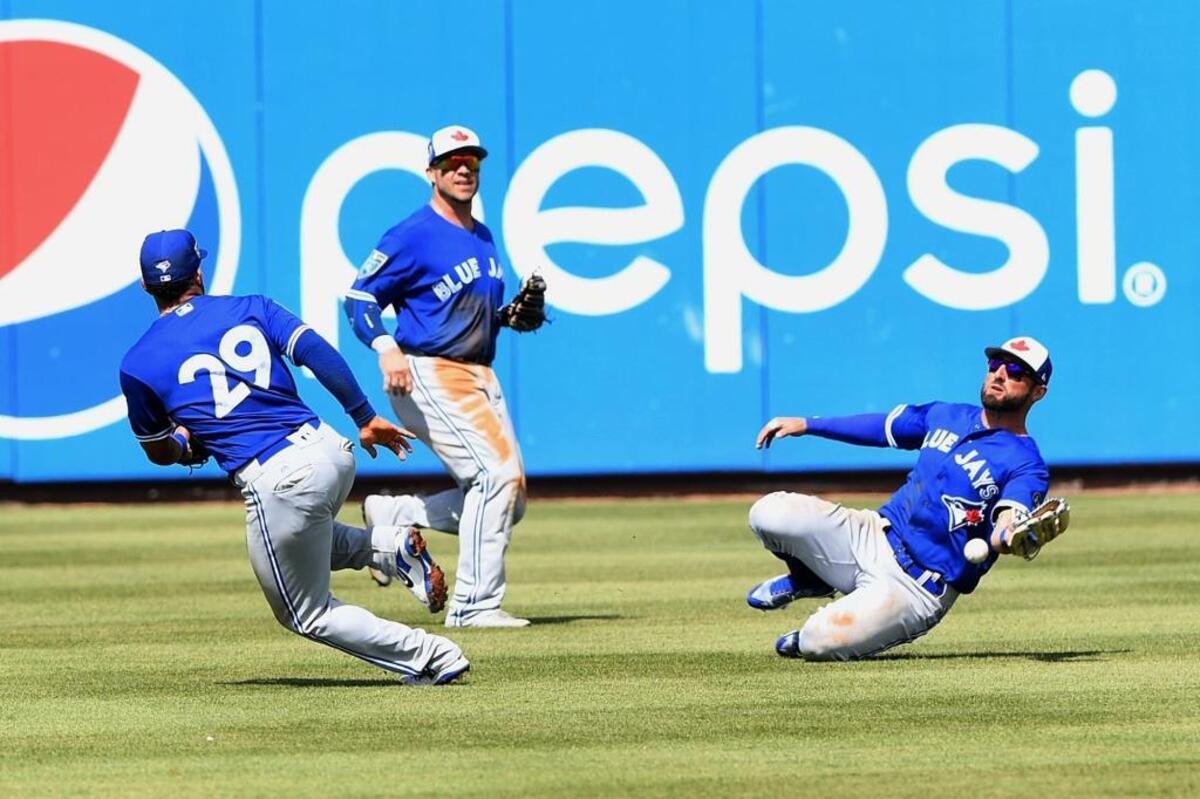 Three Blue Jays converge on the ball but can’t make the catch during Thursday’s game against the Pirates in Bradenton.
