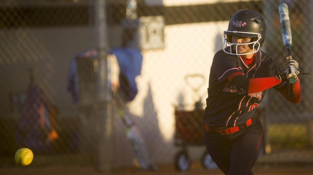 Manatee’s Madison Bradford swings at a pitch during the Hurricanes’ game against Seminole Osceola during the Palmetto Spring Break softball tournament at Blackstone Park in Palmetto.