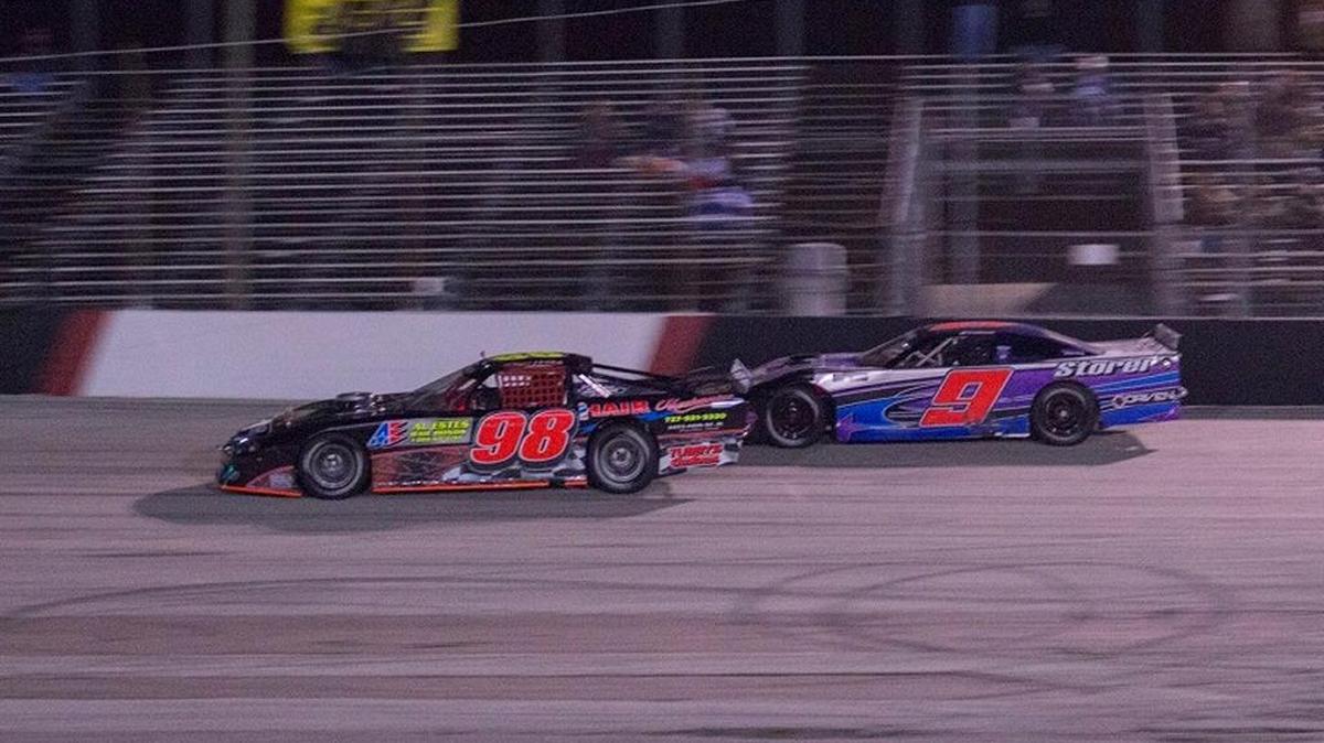 Roger Welch (98) and Brooke Storer battle during the 50-lap Sportsman feature during Saturday night’s race card at Desoto Speedway.