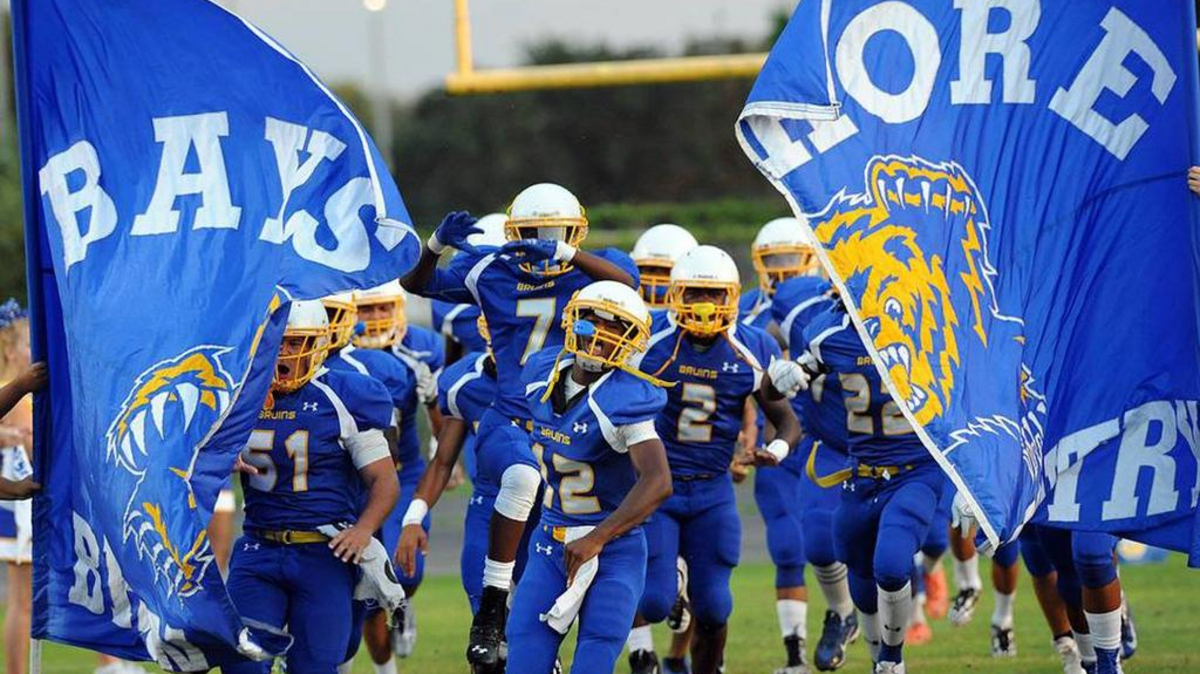 The Bayshore Bruins football team runs onto the field during a 2015 game at home against Southeast High.