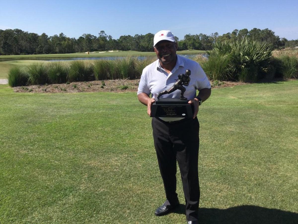 Ohio State legend Archie Griffin, the only two-time Heisman Trophy winner in history, holds a replica trophy following his annual charity golf tournament at The Concession Golf Club in East Manatee County.