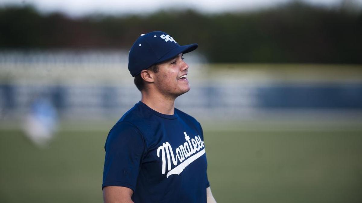 Left-handed pitcher Brendon Little laughs with his teammates in the outfield during the SCF Manatee's baseball practice at State College of Florida on Wednesday afternoon, January 26, 2017 in Bradenton.