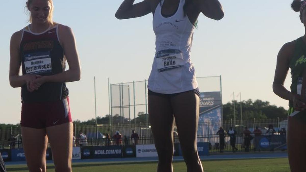 St. Augustine’s University senior Tia-Adana Belle celebrates atop the podium after winning the 400-meter hurdles for the third straight year at the NCAA Women’s Division II Outdoor Track and Field National Championships.