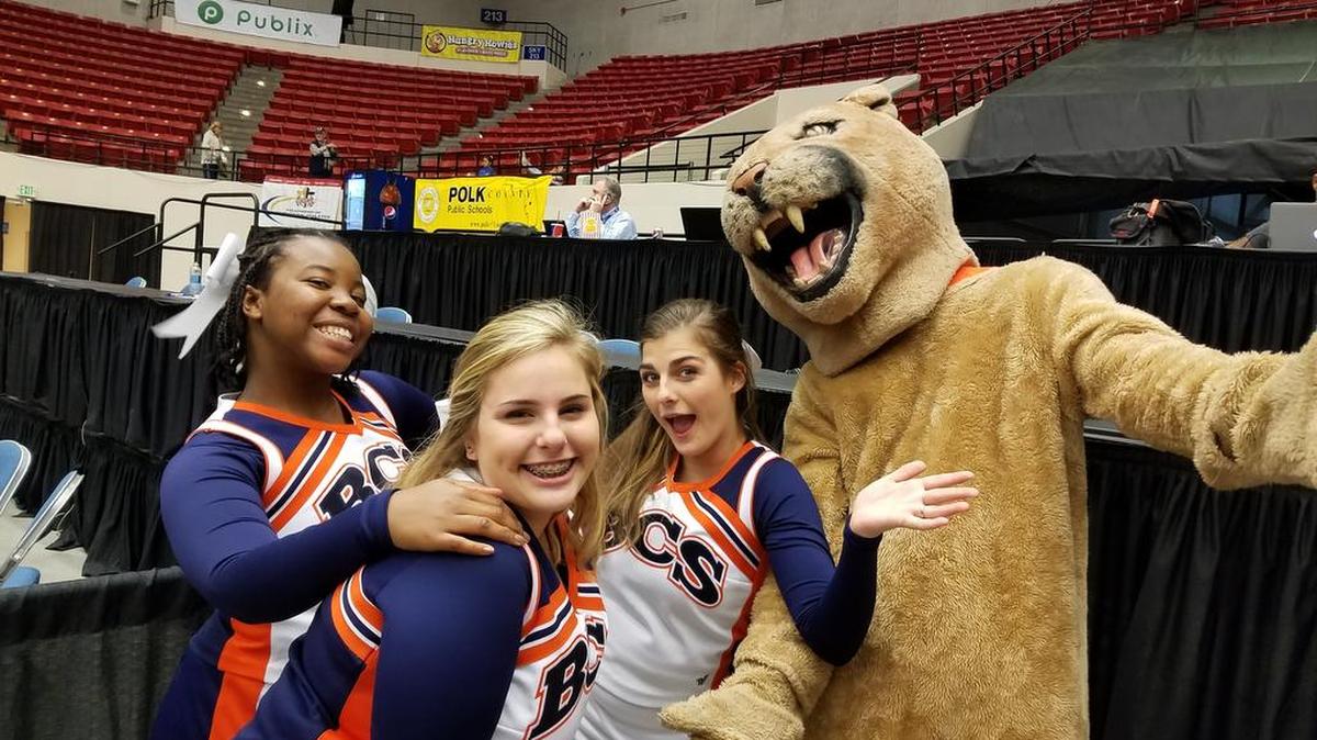 Bradenton Christian cheerleaders (from left) Yrnanda Venerin, Charlotte Williams and Kristina Pullaro have fun with the Panthers mascot during a basketball game this past season.