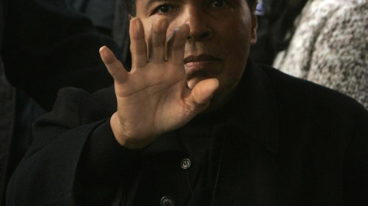 Muhammad Ali waves to people gathered for the dedication of the Muhammad Ali Center in Louisville, Ky., on November 20, 2005.
