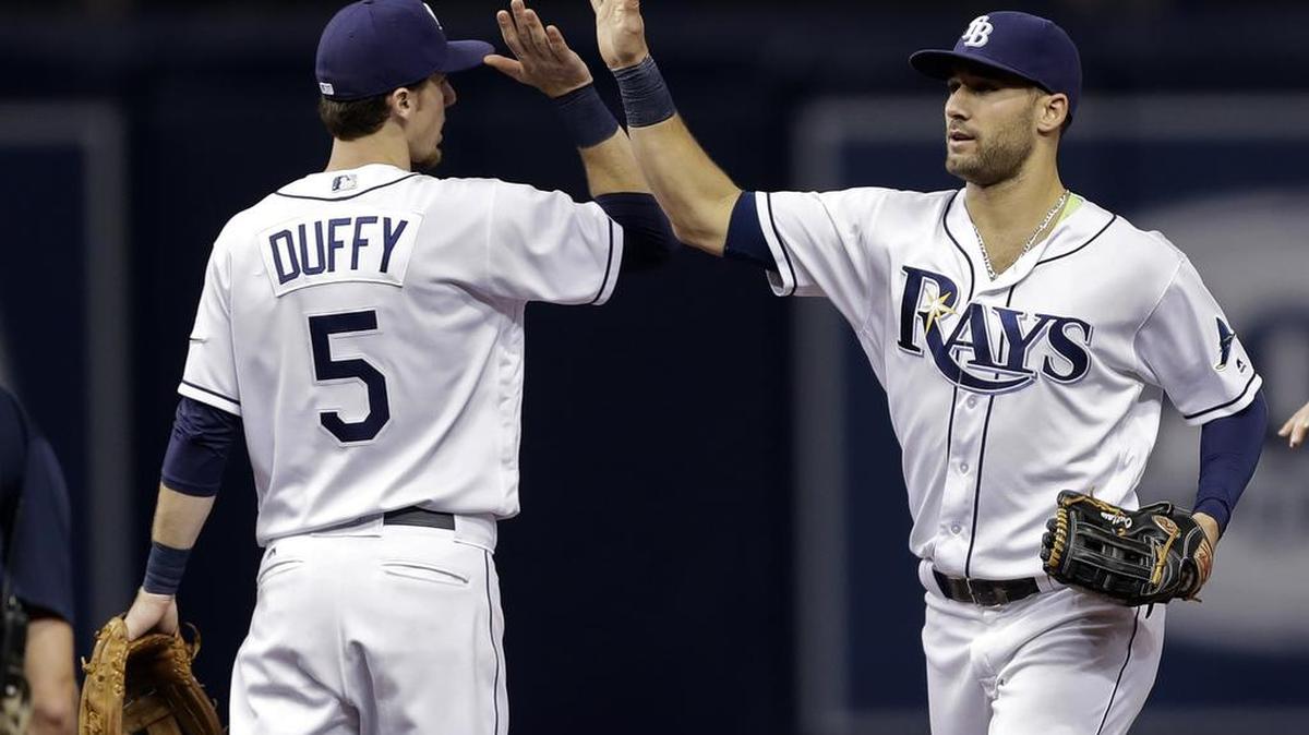 Tampa Bay center fielder Kevin Kiermaier, right, high-fives shortstop Matt Duffy after the Rays defeated Toronto on Saturday in St. Petersburg.