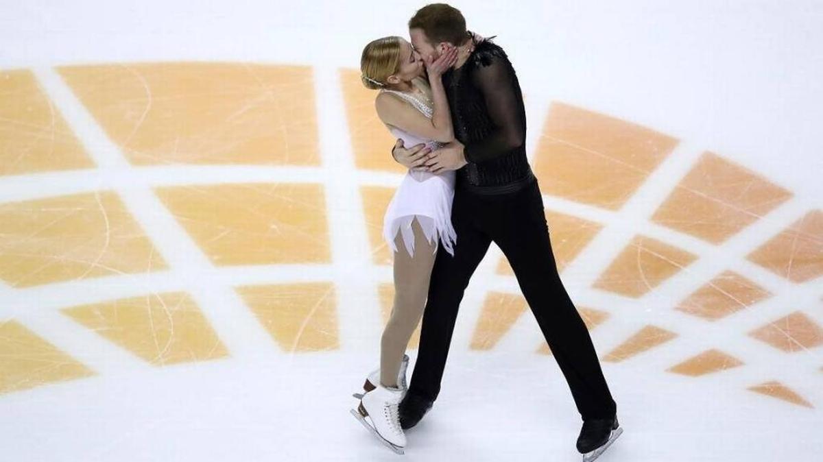 Tarah Kayne, left, kisses Danny O’Shea as they perform during the pairs free skate event at the U.S. Figure Skating Championships in San Jose, Calif., on Saturday. They train in Ellenton.