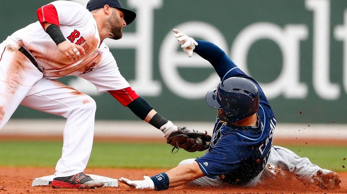 Boston second baseman Dustin Pedroia tags Tampa Bay’s Curt Casali at second trying to stretch a single into a double during the second inning Sunday.
