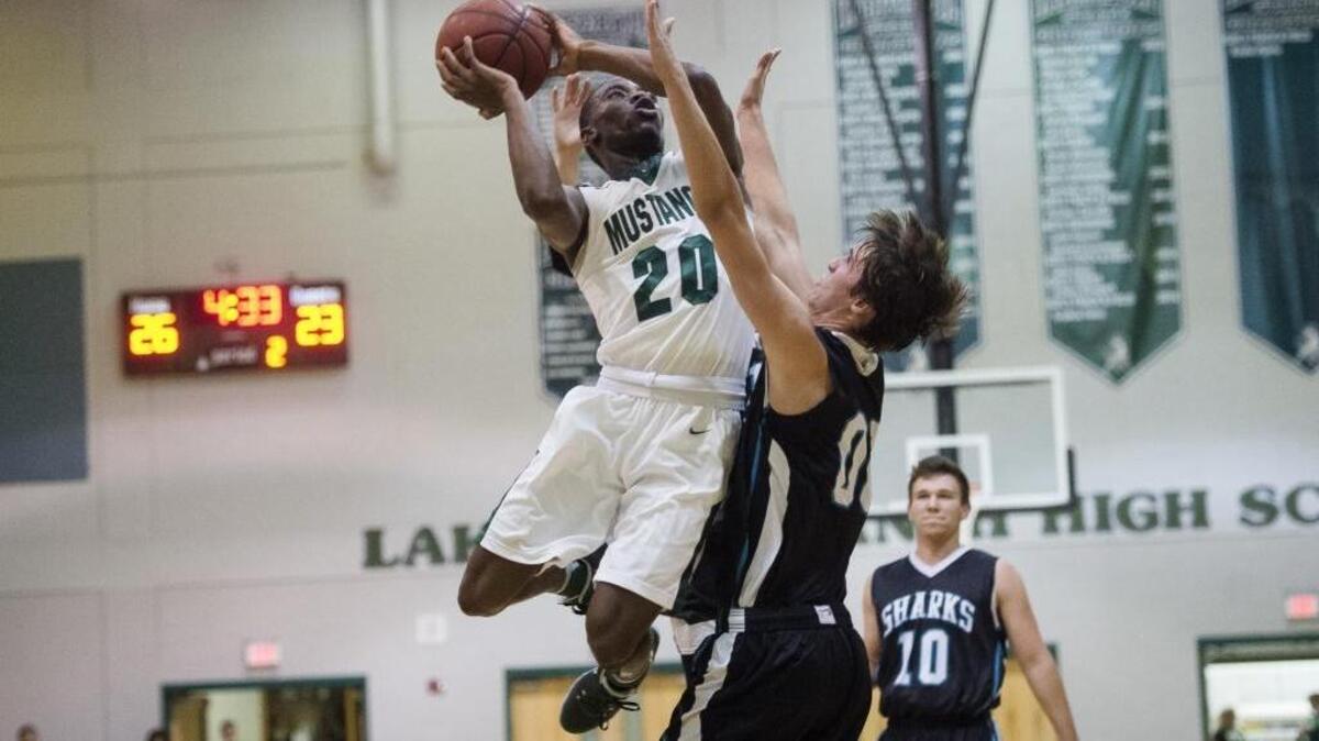 Lakewood Ranch’s Devin Twenty flies through the air for a layup during a Feb. 16 contest against visiting Gulf Coast. The Mustangs are adding two 6-foot-6 players who are transfers. They will help fill the shoes of Twenty and other players who have graduated.