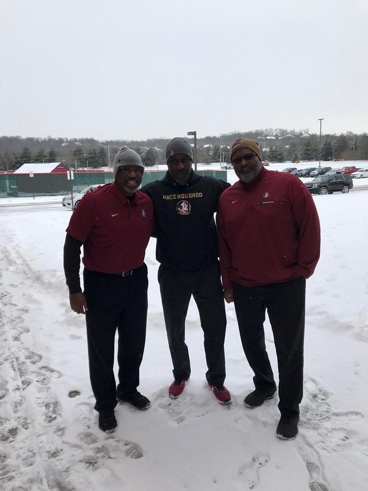 FSU coaches Raymond Woodie, center, with Harlon Barnett, left, and Odell Haggins, helped elevate the Seminoles’ recruiting class despite a late start.