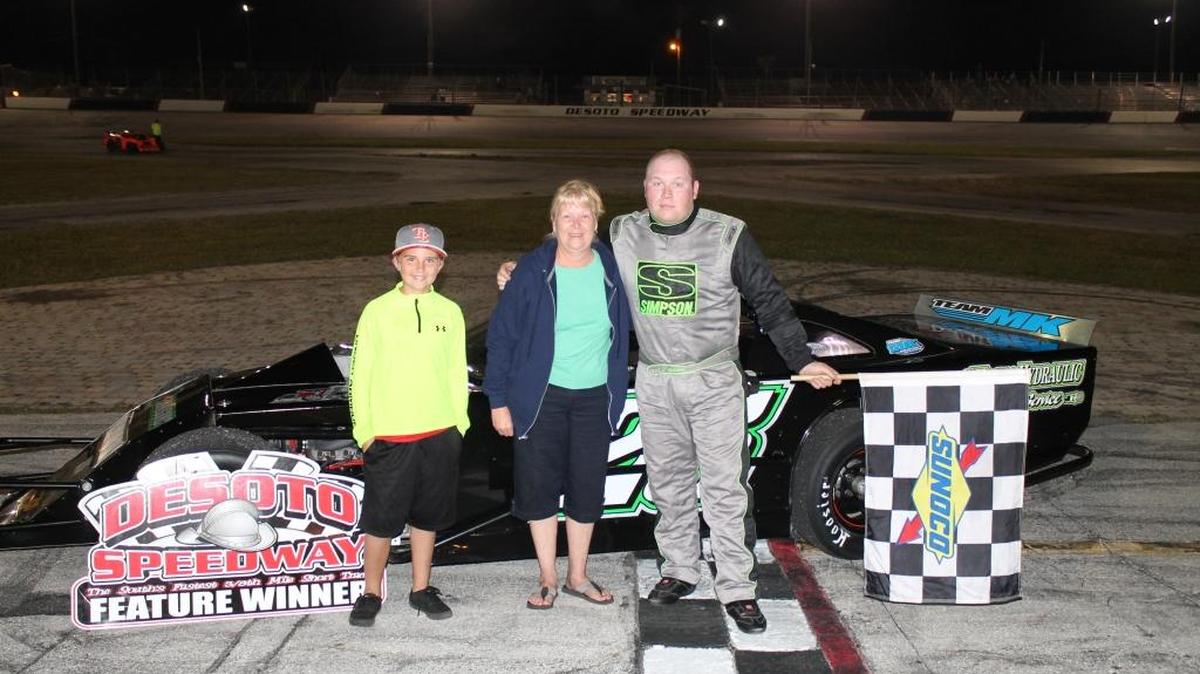 L.J. Grimm celebrates his win Saturday night in the Open Wheel Modified featured race at Desoto Speedway.