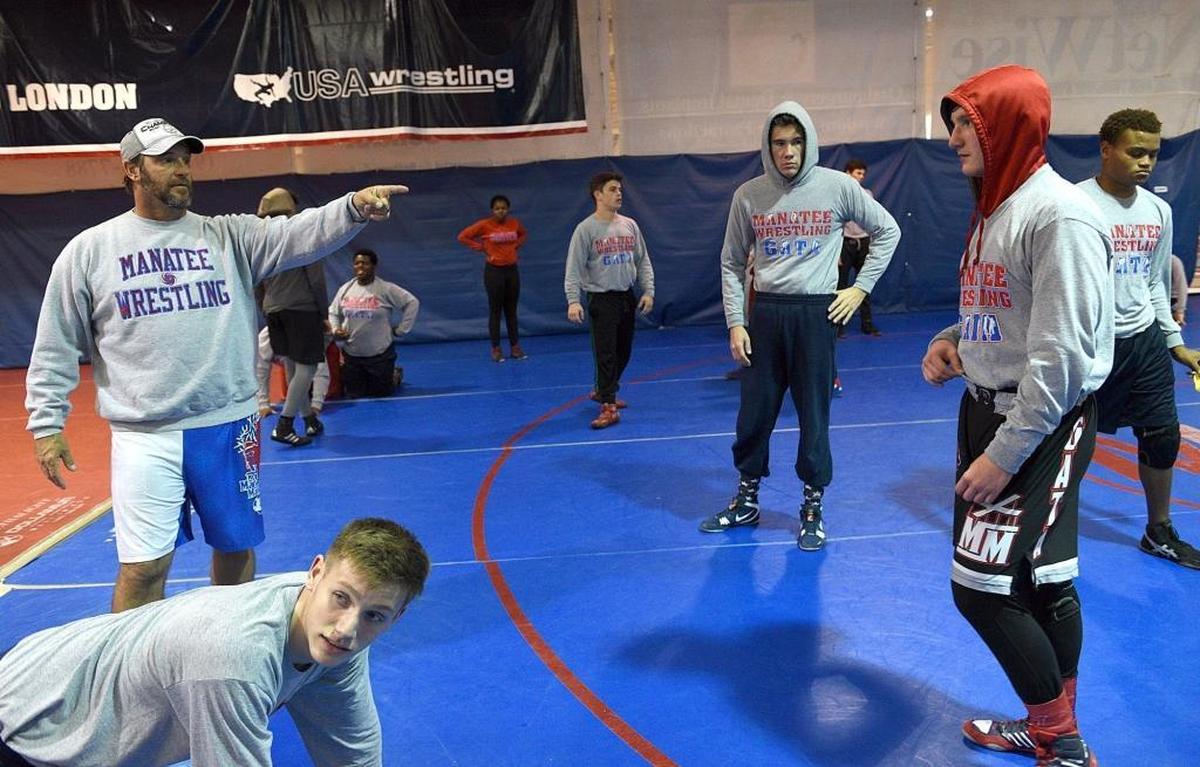 Coach Andrew Gugliemini directs Manatee High’s wrestling practice.
