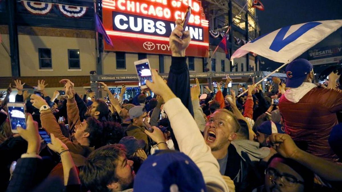 Chicago Cubs fans celebrate in front of Wrigley Field in Chicago on Wednesday, Nov. 2, 2016, after the Cubs beat the Cleveland Indians 8-7 in Game 7 of the Major League World Series in Cleveland.
