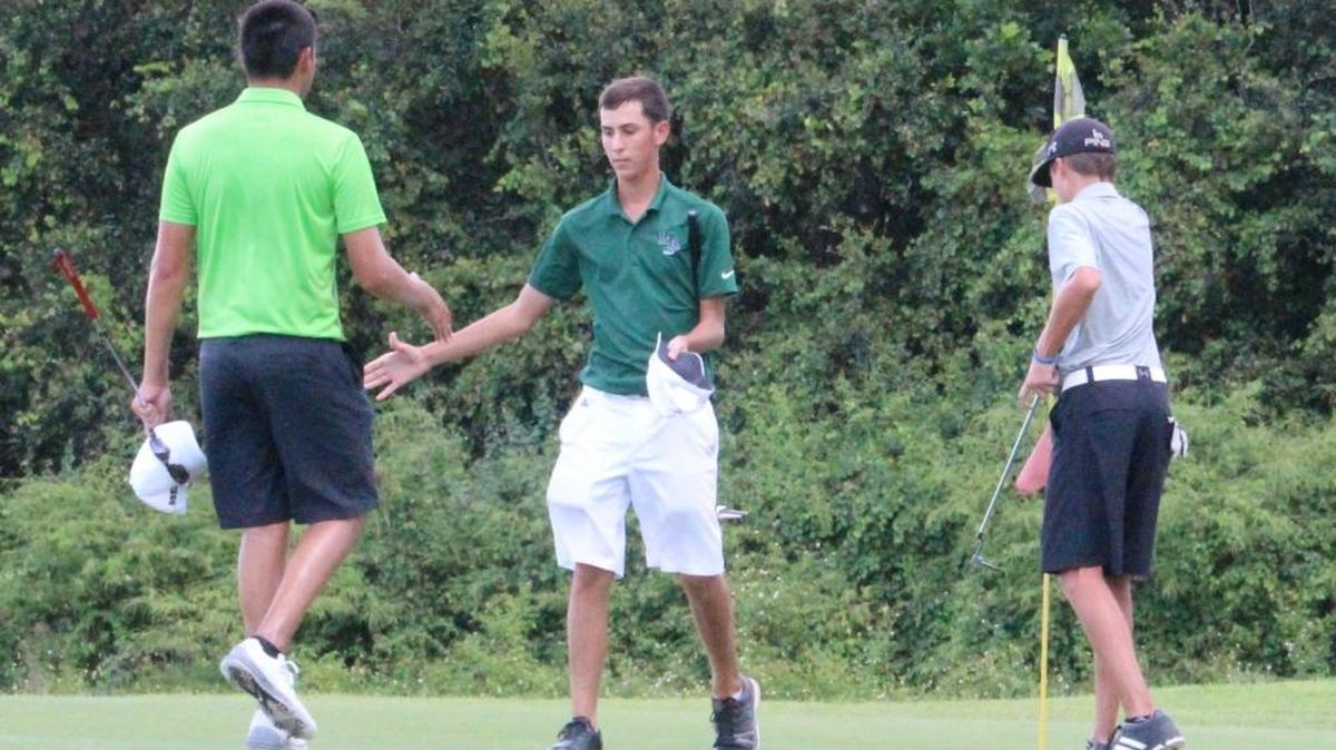 Ryan Kinkead of Saint Stephen’s, left, and Louis DelFabro of Lakewood Ranch High School exchange handshakes after 18 holes of golf Saturday at the Manatee County Golf Tournament.