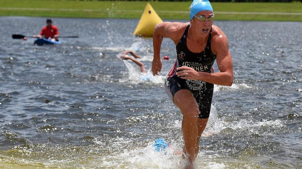 A swimmer in the first group makes it out of the water during the pro Major League Triathlon race Saturday at Nathan Benderson Park.