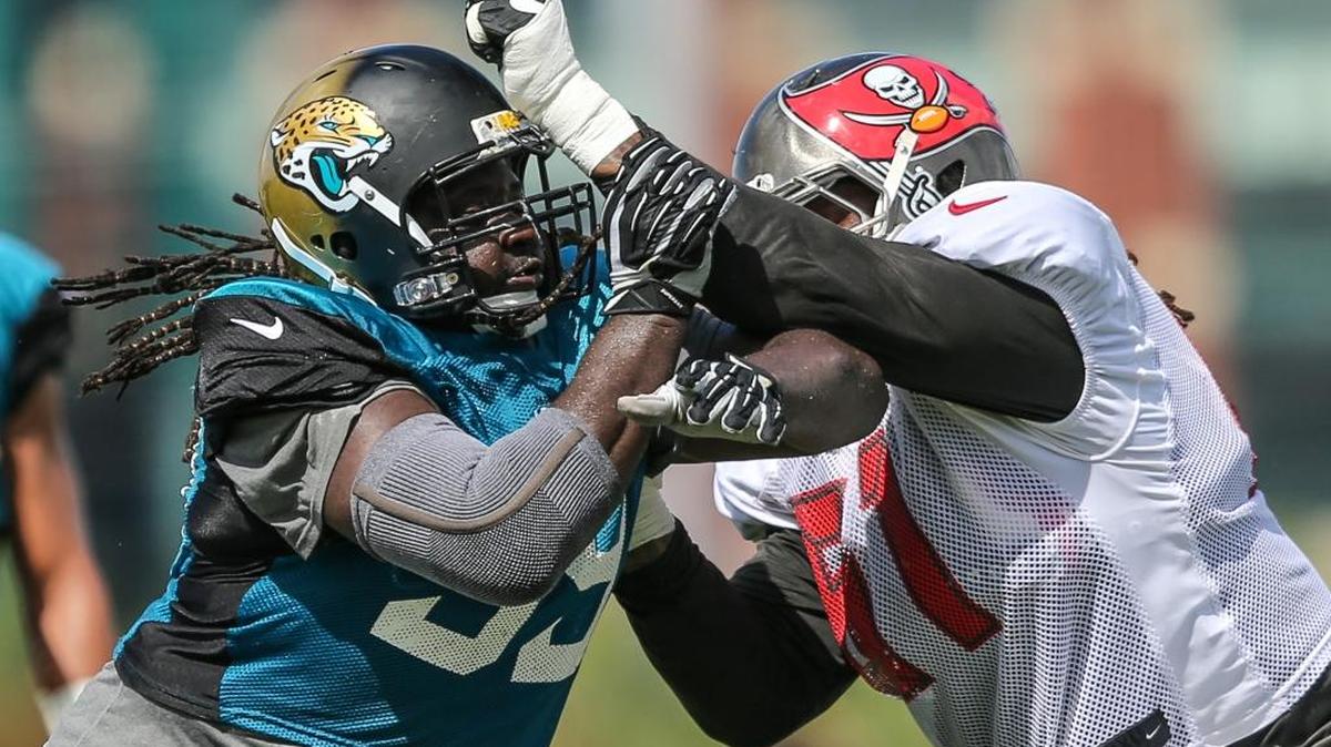 Jacksonville defensive tackle Sen’Derrick Marks, left, and Tampa Bay center Josh Allen compete in a drill during a joint workout at Florida Blue Field in Jacksonville on Wednesday.