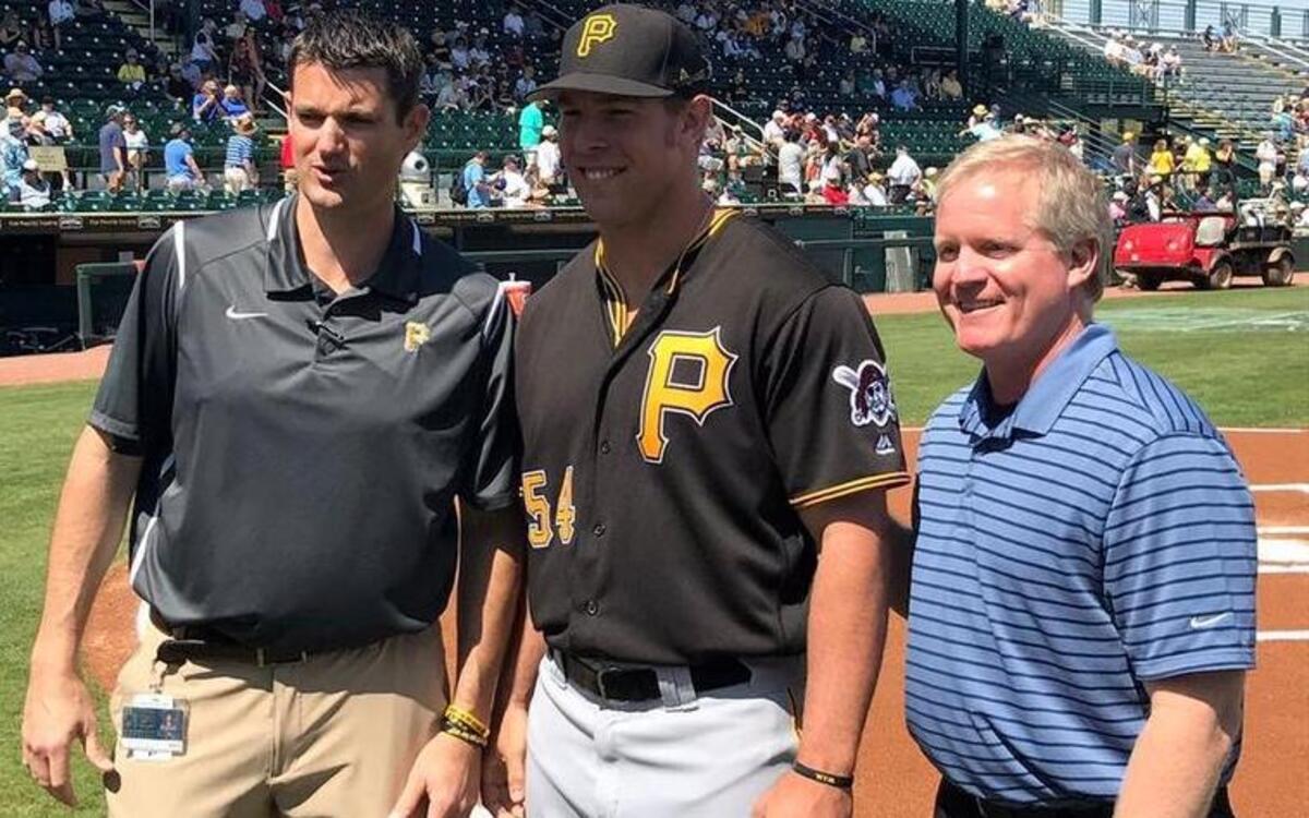 Bradenton native Michael Suchy, center, collects his 2016 Florida State League championship ring next to Pirates general manager Neal Huntington, right, earlier this spring.