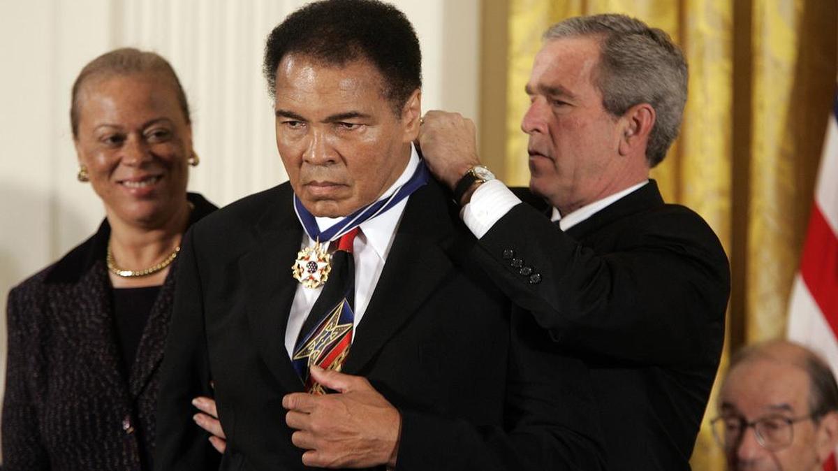 President George W. Bush presents boxing legend Muhammad Ali the Presidential Medal of Freedom during a ceremony at the White House in Washington, D.C., on November 9, 2005.