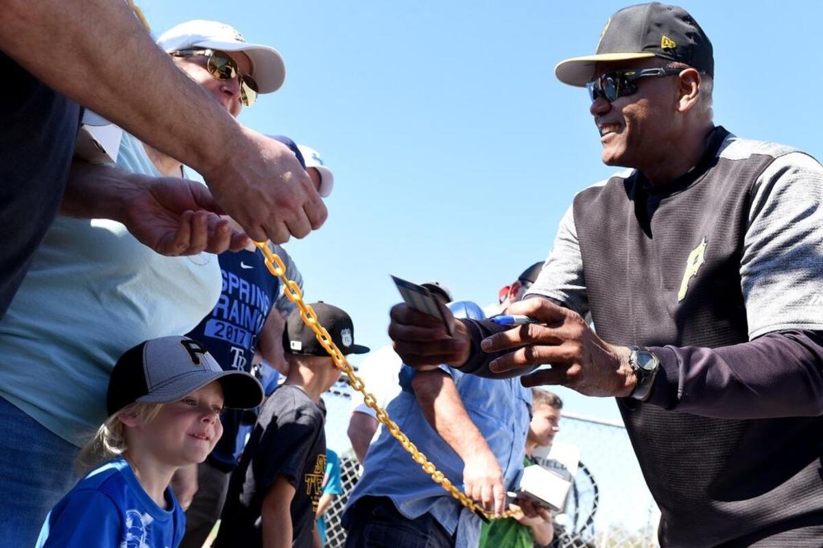 Omar Moreno, who played for the Pittsburgh Pirates from 1975-82 as part of a 12-year major-league career, signs autographs Monday at Pirate City.