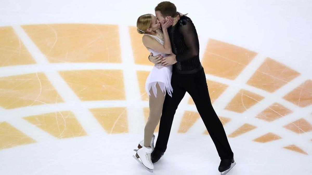Tarah Kayne, left, kisses Danny O’Shea as they perform during the pairs free skate event at the U.S. Figure Skating Championships in San Jose, Calif., on Saturday. They train in Ellenton.