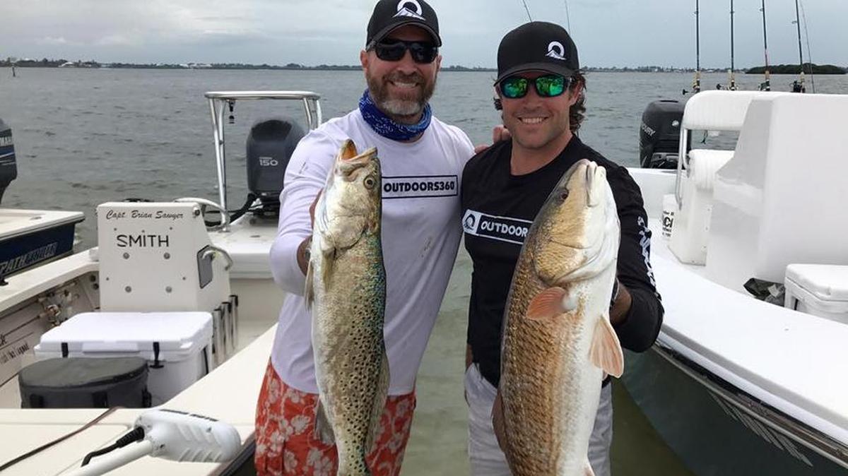 Rob Chapman IV (left) and Adam Papka hold Team Outdoors360’s second-place catch in the Sticken Pigz Fishing Tournament on April 22.