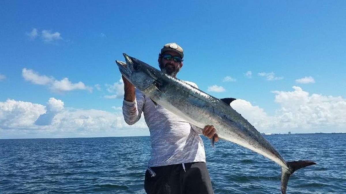 Capt. Josh Prunier with a 39-pound kingfish caught grouper fishing in 10 feet of water inside Tampa Bay.