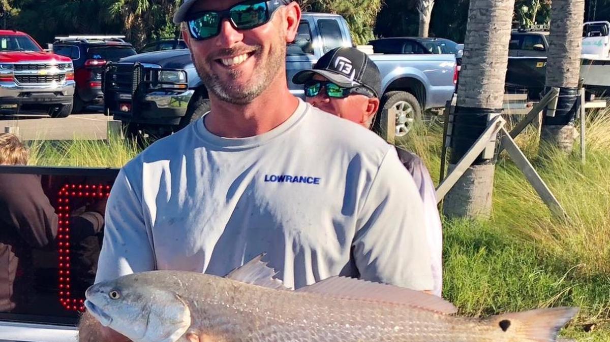 Capt. Josh Bibler displays won of his prize-winning redfish.