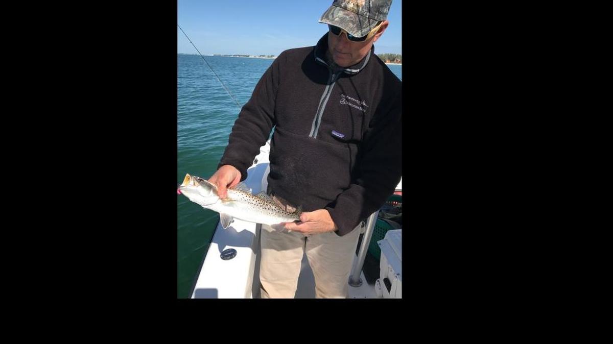 Capt. Todd Romine shows a trout caught on a Captain Chappy jig.