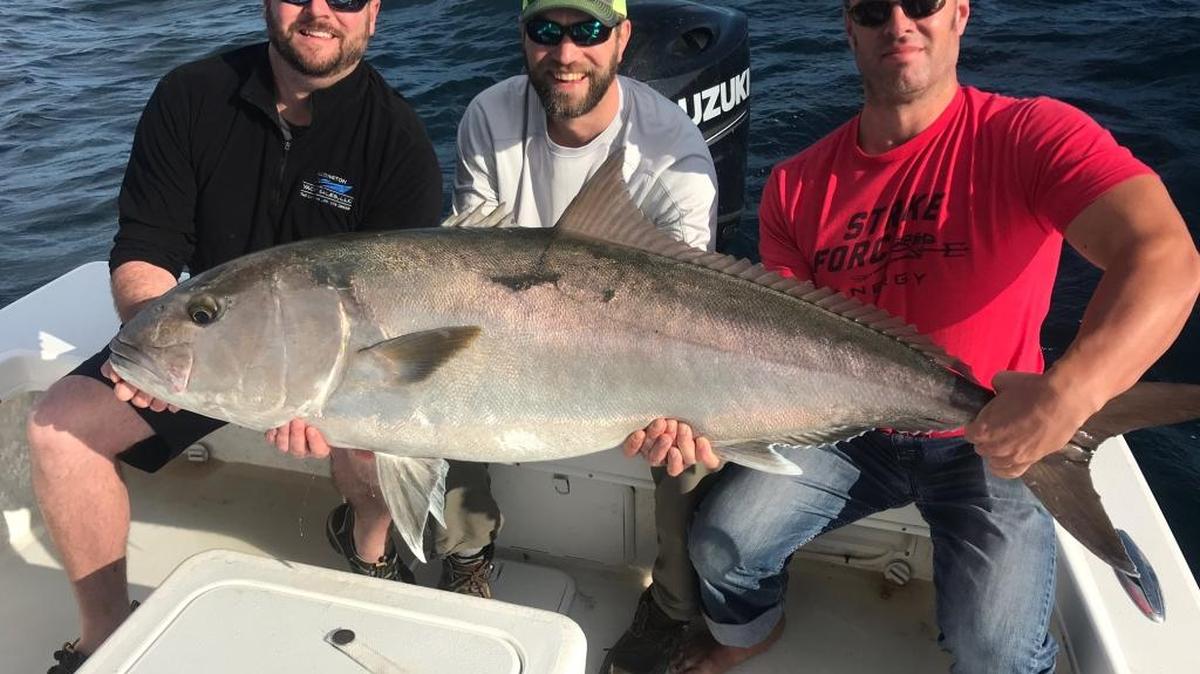 Anglers from Michigan hold the 78-pound amberjack they caught while fishing with Capt. Jason Stock.