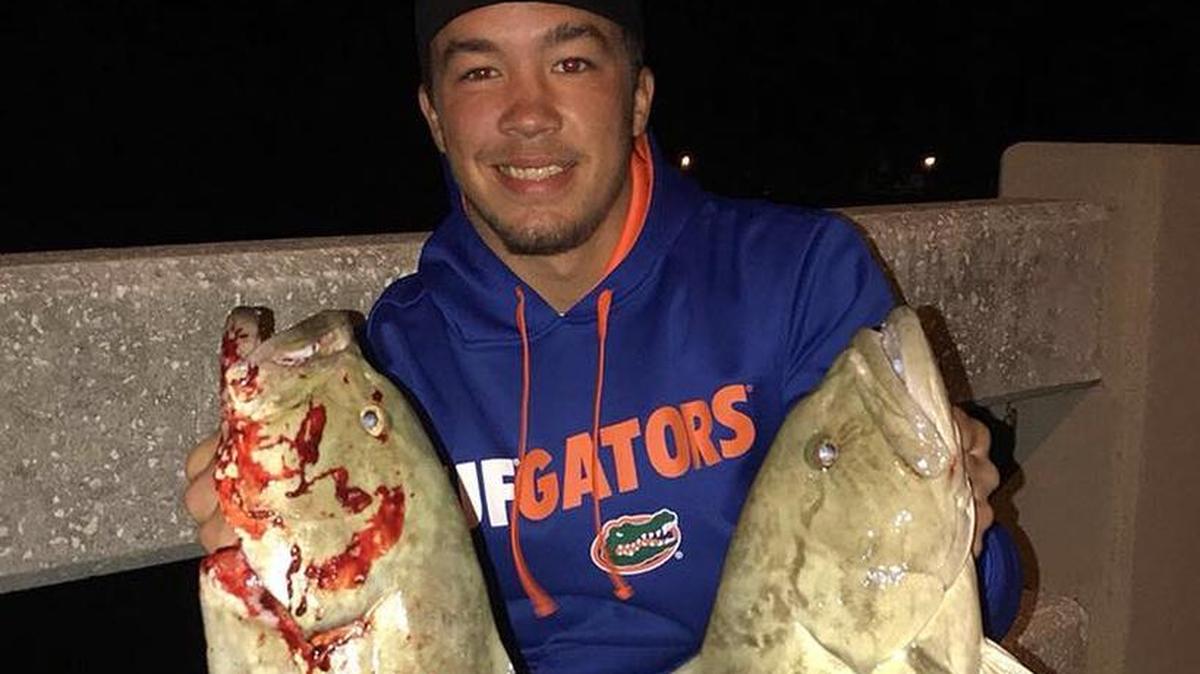 Brendan Baldwin with a pair of grouper caught late Wednesday night from a local bridge.
