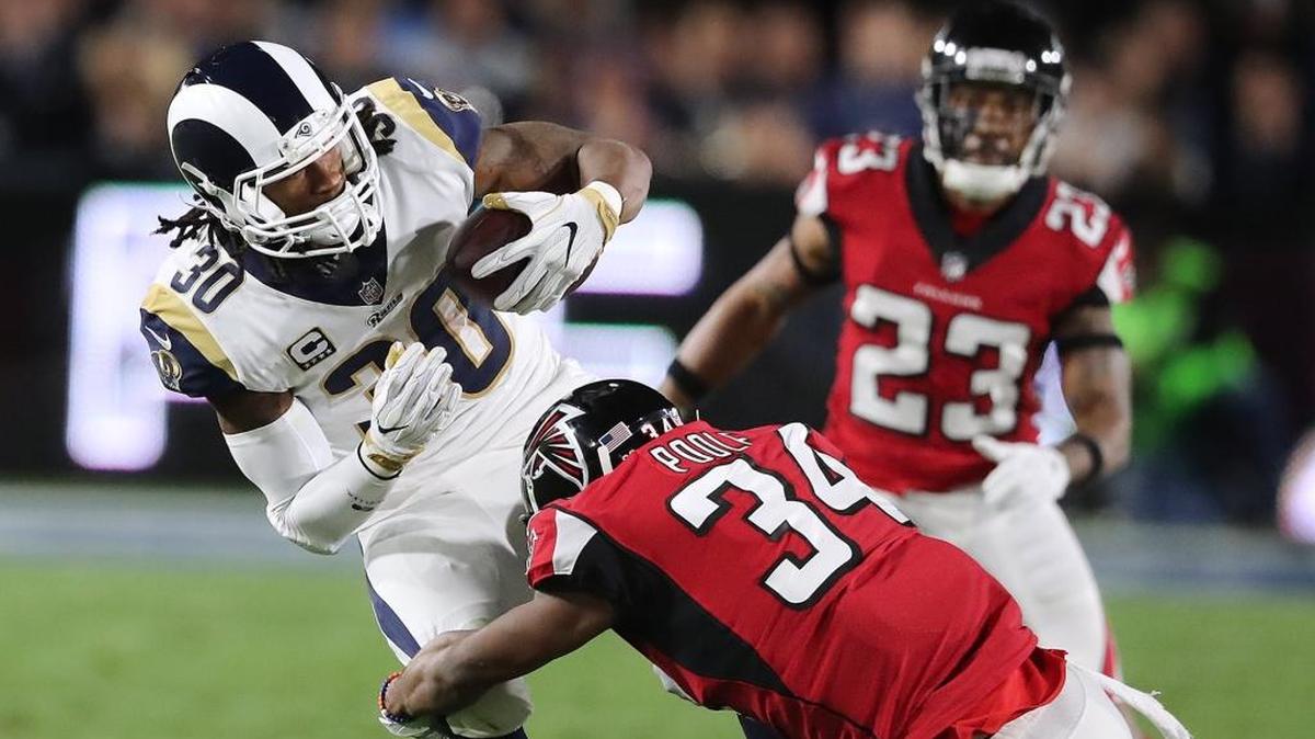 Atlanta Falcons cornerback Brian Poole tackles Los Angeles Rams running back Todd Gurley for a short gain during the first quarter of Saturday’s playoff game.
