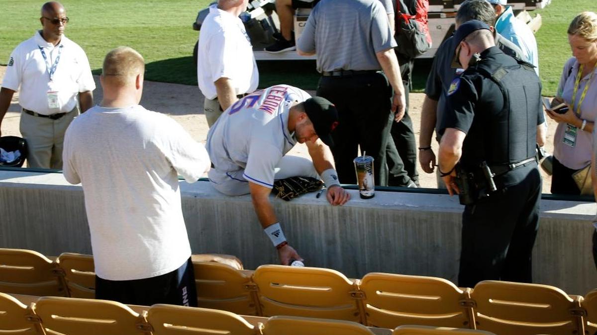 Scottsdale Scorpions outfielder Tim Tebow waits with a fan following Tebow’s debut against the Glendale Desert Dogs on Tuesday during the Arizona Fall League in Glendale, Ariz. Tebow comforted a fan who was having a seizure.