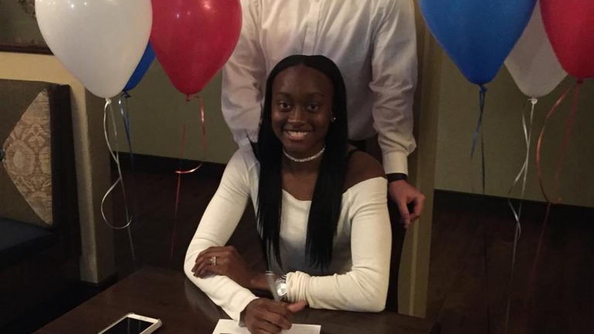 Deanay Watson, front, sits with her letter of intent during the Palmetto High School girls basketball team’s annual banquet on Feb. 17. Watson signed with Three Rivers Community College in Norwich, CT. Behind Watson is Palmetto coach Travis Persinger.