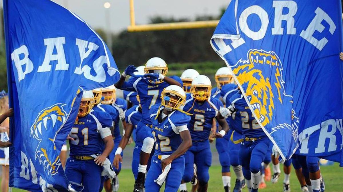 The Bayshore Bruins football team runs onto the field during a 2015 game at home against Southeast High.