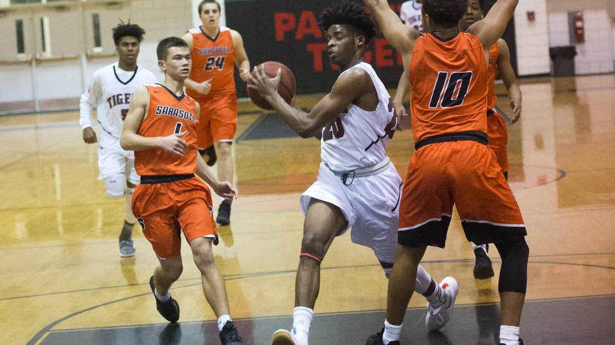 Palmetto’s Daquan Krice fights off Sarasota defense during the district playoffs on Feb. 8. Kirce was one of three Tigers in double figures during their regional quarterfinal victory against North Port on Thursday night.