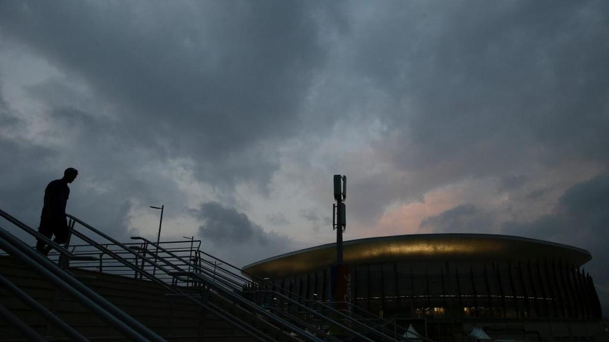 A man walks down the steps in front of the Carioca Arena 1 at Olympic Park ahead of the 2016 Summer Olympics in Rio de Janeiro, Brazil, Aug. 2, 2016.