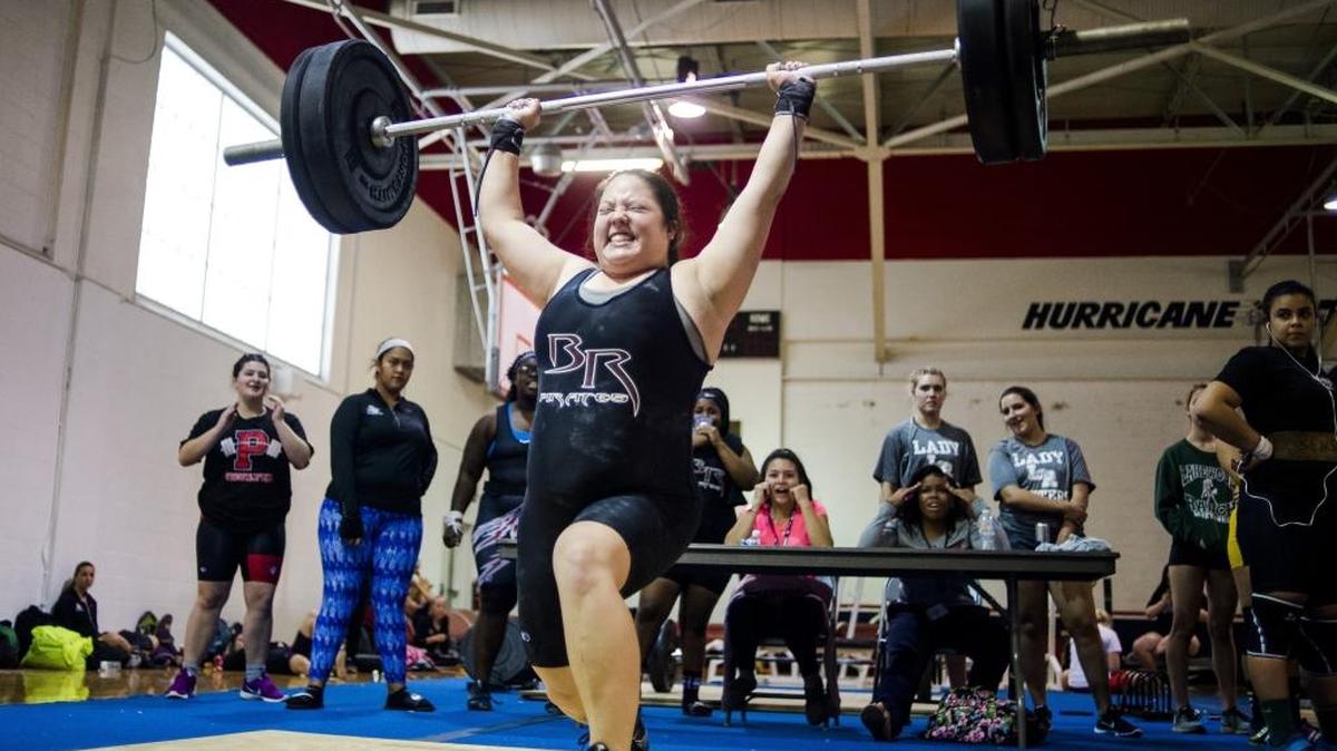 Sierra Rawley, of Braden River High School, pushes herself to the limit on her last lift during the Girls District Weightlifting competition at Manatee High School on Tuesday afternoon, January 10, 2016 in Bradenton.