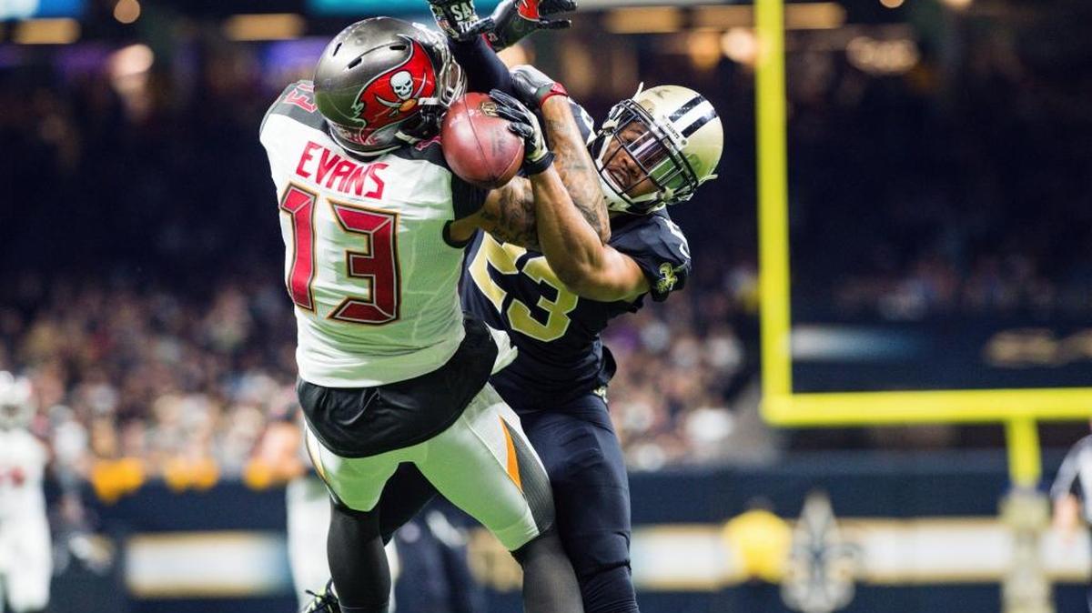 Tampa Bay Buccaneers wide receiver Mike Evans can’t hold on to the pass while defended by New Orleans Saints cornerback Marshon Lattimore during Sunday’s game. Evans was suspended by the NFL for one game for hitting Lattimore from behind during an incident near the Bucs’ sideline.
