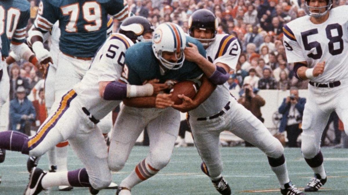 Dolphins fullback Larry Csonka plows between Vikings LB Jeff Siemon (50) and safety Paul Krause for one of his two touchdowns in the Dolphins’ 24-7 Super Bowl VIII win.